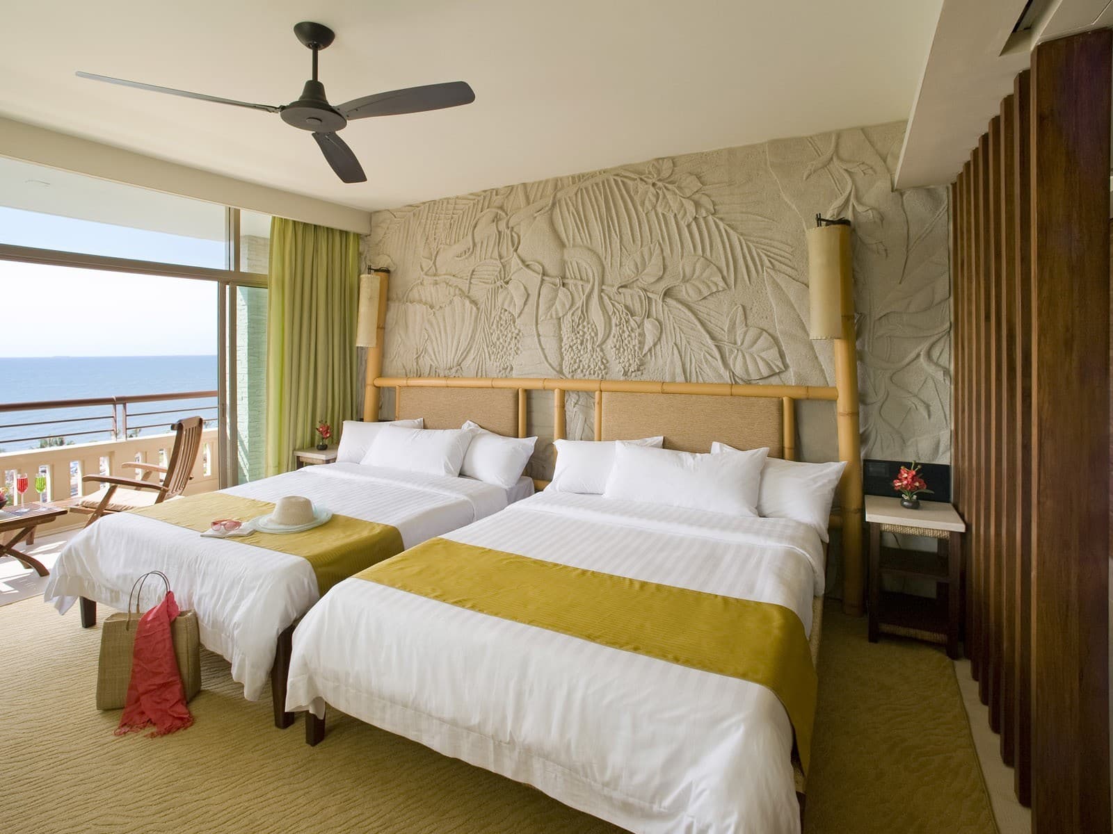 Real family-oriented room with two beds, balcony, and bright resort-style interior